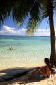 Beach scene with lagoon and palm tree on the island of Moorea. MR