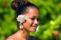 Tahitian woman wearing a tropical flower in her hair on the island of Moorea. MR