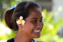 Tahitian woman wearing a plumeria flower in her hair on the island of Moorea.