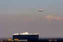 Boeing 747 airliner landing at LAX with snow covered mountains in background. Los Angeles, California.