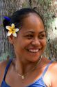 Tahitian woman wearing a plumeria flower in her hair on the island of Moorea.