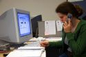 Office worker using a computer and cell phone. MR