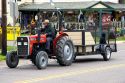 Amish man driving a tractor through the town of Berlin, Ohio.