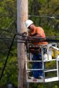 Telephone company lineman working at Hillsdale, Michigan.