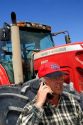 Farmer using a cell phone in the field.