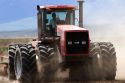 Four wheel drive tractor with dual tires planting wheat in Camas County, Idaho.