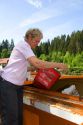 A woman recycling trash at Gerardmer, France.