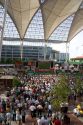 A crowd outdoors at the Munich airport watch a 2006 World Cup match on big screen televisions, Germany.