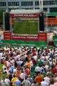 A crowd outdoors at the Munich airport watch a 2006 World Cup match on big screen televisions, Germany.