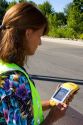 A woman using a handheld GIS device in the field, Boise, Idaho.