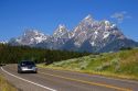 Automobile driving on highway near the Teton Mountains, Wyoming.