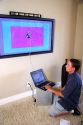 Technician installs and calibrates flat screen plasma television.