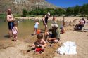 Adults and children play on the beach and in the water at Sandy Point near Boise, Idaho.