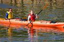 People sea kayaking in the Bay of Fundy at St. Martins, New Brunswick, Canada.
