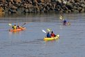 People sea kayaking in the Bay of Fundy at St. Martins, New Brunswick, Canada.