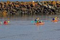 People sea kayaking in the Bay of Fundy at St. Martins, New Brunswick, Canada.