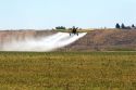 Cropduster applying chemical spray on field in Eastern Oregon.