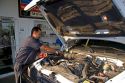 A mechanic changing the oil on an automobile in Boise, Idaho. MR