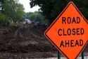 Road closed ahead sign due to sewer work being done in Oceola, Iowa.