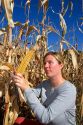 A female farmer looks at feed corn in Canyon County, Idaho. MR