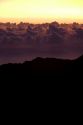 Sunrise above the clouds on the island of Maui, Hawaii atop Mount Haleakala.