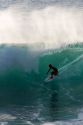 Surfing on waves in the pacific ocean off the island of Maui, Hawaii.