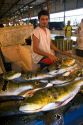 A vendor selling peacock bass at a fish market in Manaus, Brazil.