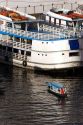 Water taxi among amazon river boats at sunrise in Manaus, Brazil.