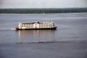 Cruise boat and small river boats on the Amazon at Manaus, Brazil.