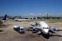 Airplanes and ground crews at the Aeroparque city Airport in Buenos Aires, Argentina.