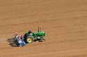 Aerial view of a farmer on a tractor planting seed in Canyon County, Idaho.