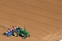 Aerial view of a farmer on a tractor planting seed in Canyon County, Idaho.