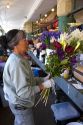 A florist arranging flowers at the Pike Place Market in Seattle, Washington.