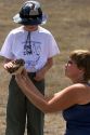 Wildlife biologist showing a fledgling burrowing owl to an 11 year old boy near Mountain Home, Idaho.