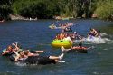 People in inflatable tubes and rafts floating the Boise River in Boise, Idaho.