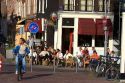 People eat and drink at an outdoor cafe in Amsterdam, Netherlands.