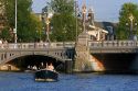 Boating cruising on the Amstel River in Amsterdam, Netherlands.