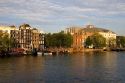 The Royal Carre Theatre and row houses along the Amstel River in Amsterdam, Netherlands.