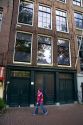 A young girl walks past the Anne Frank House in Amsterdam, Netherlands.