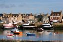 Fishing boats in the harbor at the village of Barfleur in the region of Basse-Normandie, France.