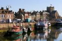 Fishing boats docked in the harbor at the village of Barfleur in the region of Basse-Normandie, France.