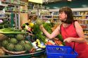 French woman shops for vegetables at a super market in the village of Barfleur in the region of Basse-Normandie, France.