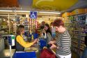 People in the checkout line of a super market in the village of Barfleur in the region of Basse-Normandie, France.