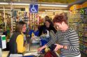 French woman pays for her groceries at a super market in the village of Barfleur in the region of Basse-Normandie, France.