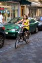 Young woman riding a rental bicycle that is a part of the Velib bike transit system in Paris, France.