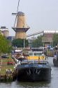 Windmill and boats at the Port of Rotterdam, Netherlands.