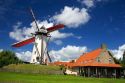 A windmill and old stone restaurant in the town of Ramskapelle in the municipality of Knokke-Heist located in the province of West Flanders, Belgium.