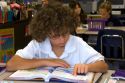 Fourth grade student reads a textbook in a classroom at a public school in Tampa, Florida.