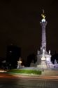 El Angel de la Independencia at night with the movement of automobile taillights in Mexico City, Mexico.