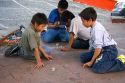 Mexican boys play a game of pogs in the plaza at Taxco in the State of Guerrero, Mexico.